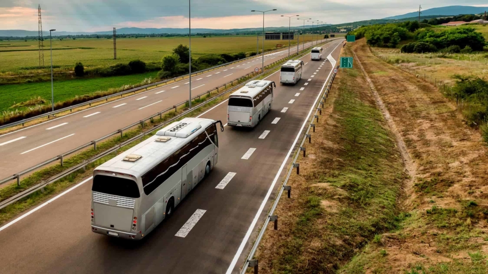Fleet of buses following each down the road