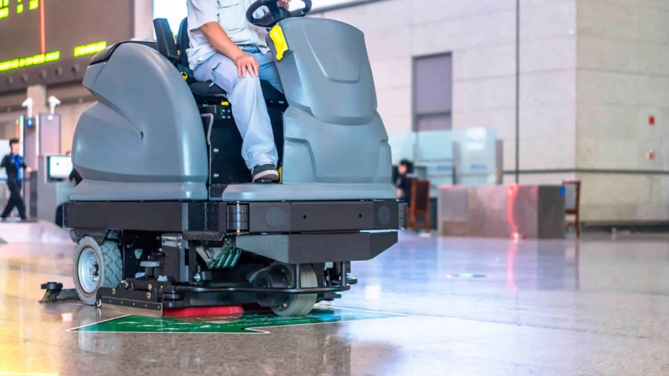 Man riding floor care machine