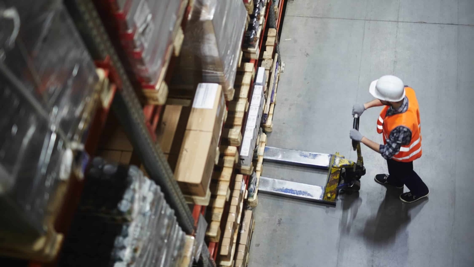 Man in a warehouse using a forklift