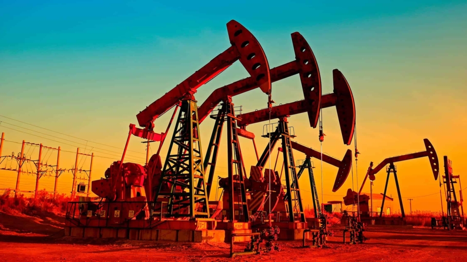 Oil pumps in a field against a beautiful sky